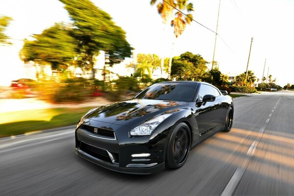 Fast black car on asphalt