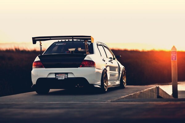 A racing car drives off into the sunset