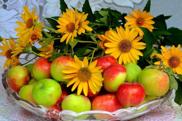 Still life of red apples and yellow flowers