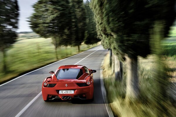 A red car driving on the road