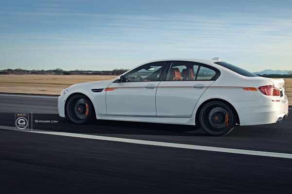 A white car rushes across the plain