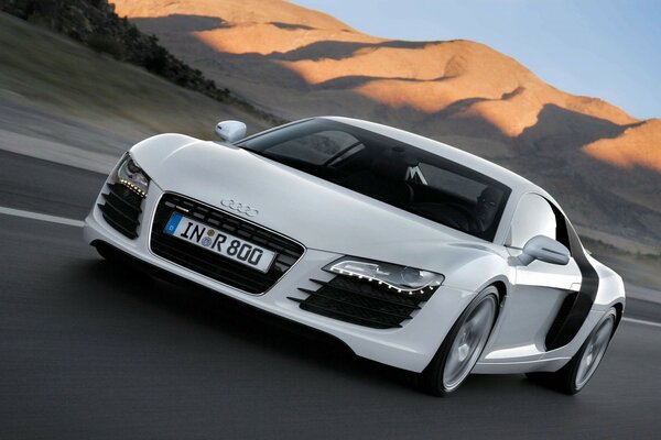 Audi R8 white car is moving fast on the highway