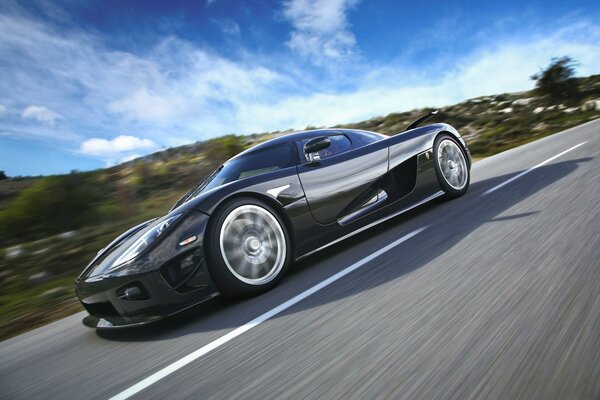 Racing car hurries along the road