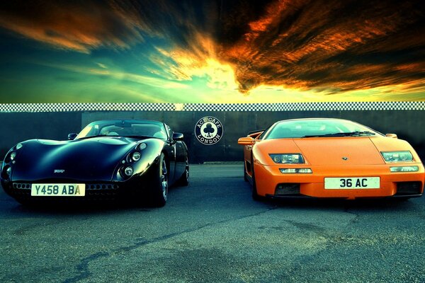 Two luxury cars on the background of the road