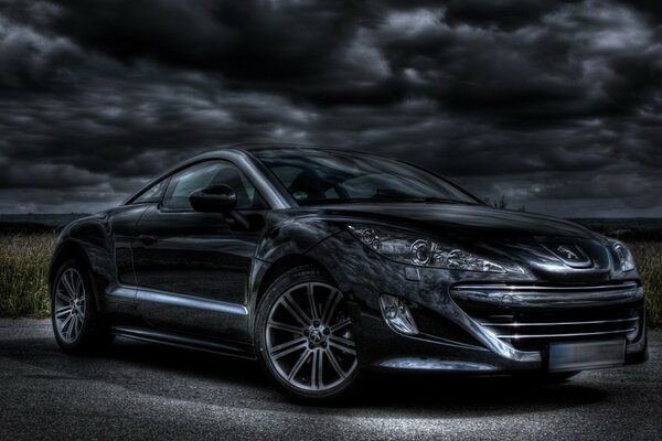 A black car against a gloomy sky