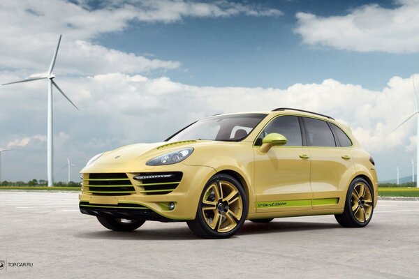 Yellow car on the background of wind turbines