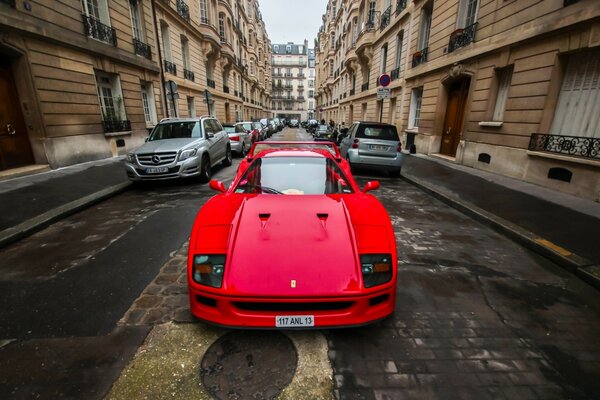 Coche rojo en una calle estrecha