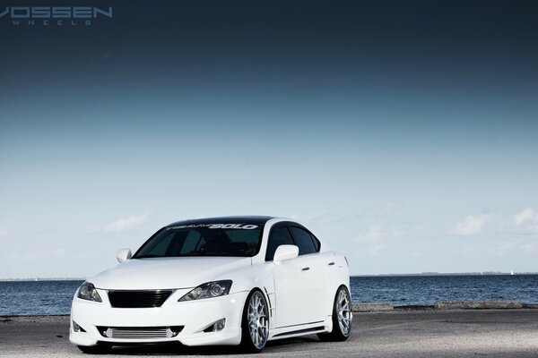 White Lexus car on the seashore