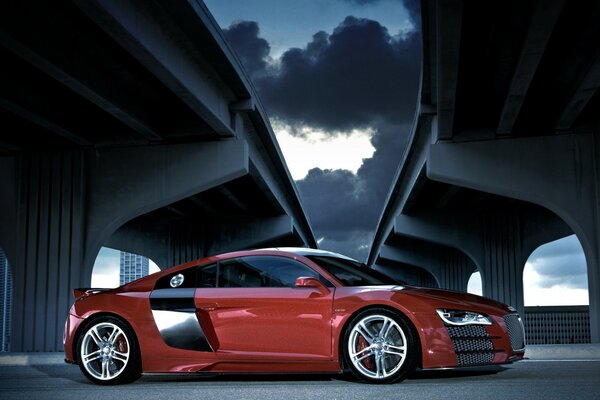 Red sports car under the bridge