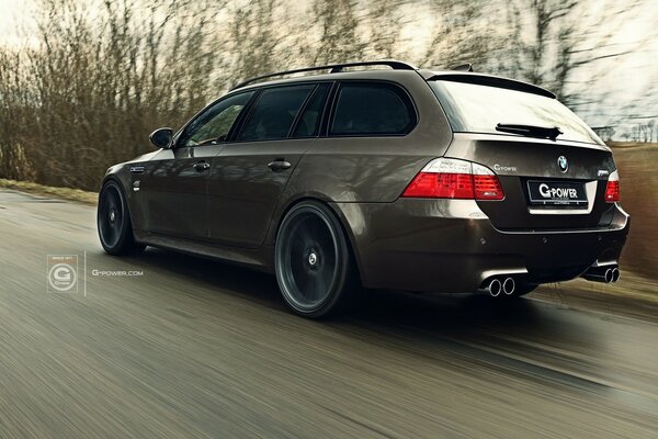 A BMW car is driving on the road