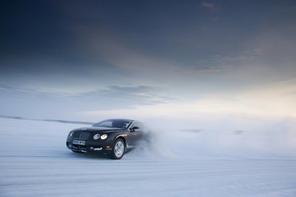 A black car on a winter landscape