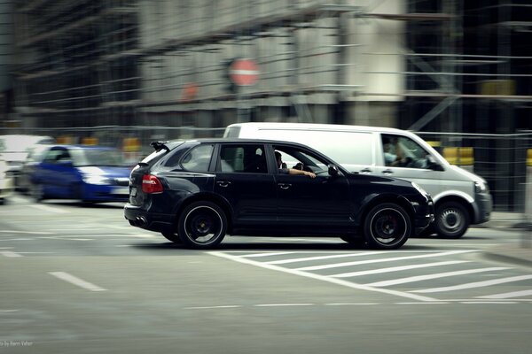 A busy city intersection. Cars are driving down the street