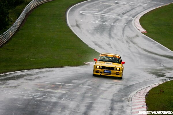 A racing car is flying on the asphalt