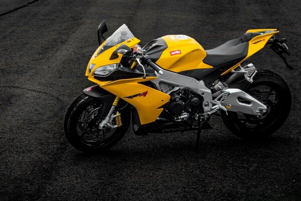 Aprilia RSV4 yellow motorcycle on the road