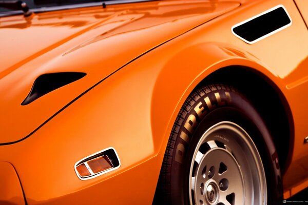 A fragment of a cool orange car