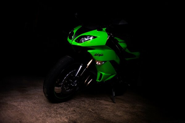 Green motorcycle on black background