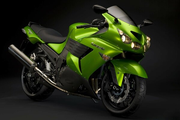 Green motorcycle on a dark background