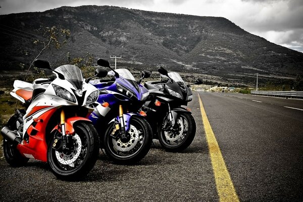 Three motorcycles on the road in the morning