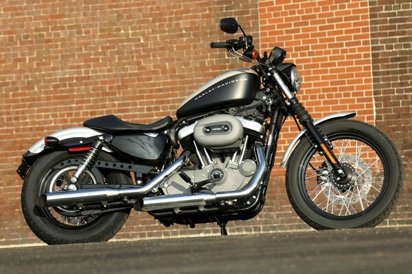 Black motorcycle on a brick wall background