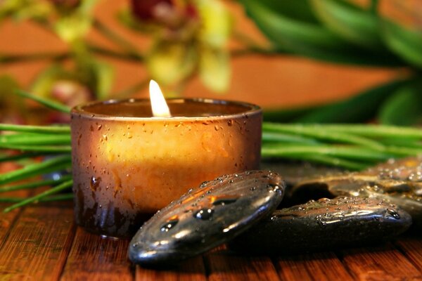 Flamme de bougie aux pierres et aux verts