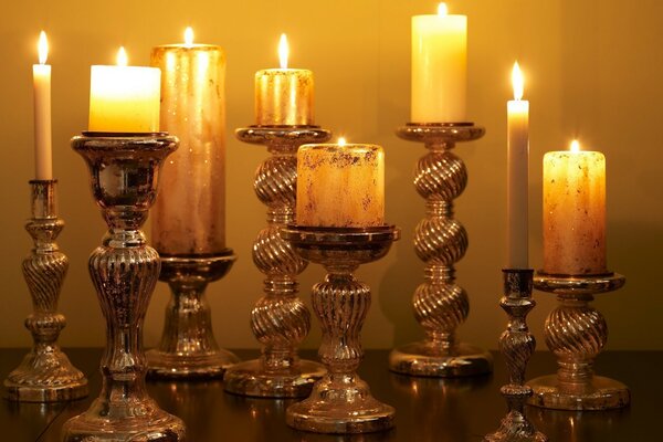 Eight burning candles in candlesticks
