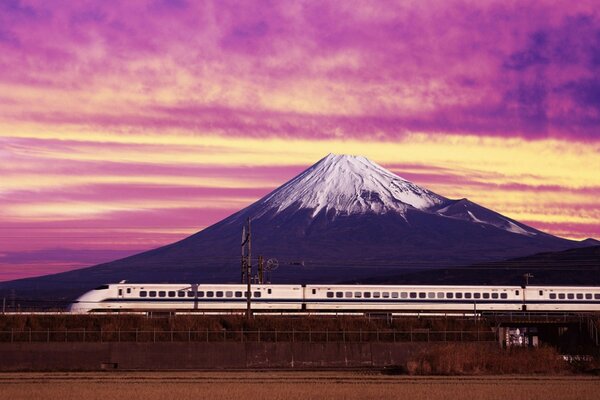 Moving high-speed train on the background of a large mountain