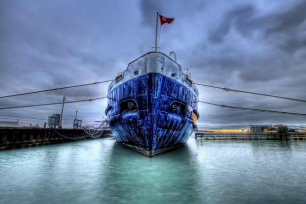 Moored ship on the shore of a reservoir