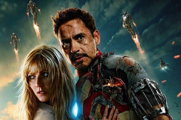 Iron Man che abbraccia la ragazza circondato da supereroi volanti