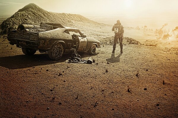 Car and driver on the background of a desert landscape