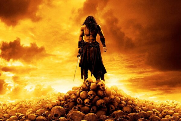 Naked man on a mountain of skulls