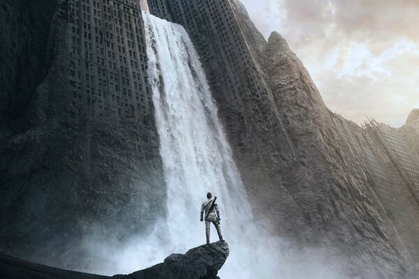 A man on the background of a waterfall