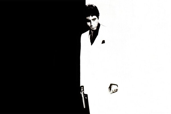 Al Pacino on a black and white background with a gun in his hand