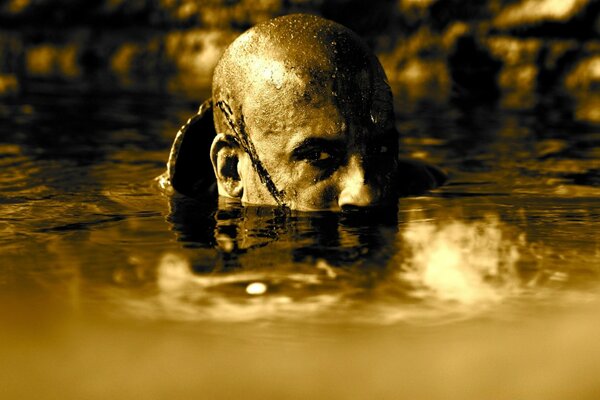 Bald man hiding in the water