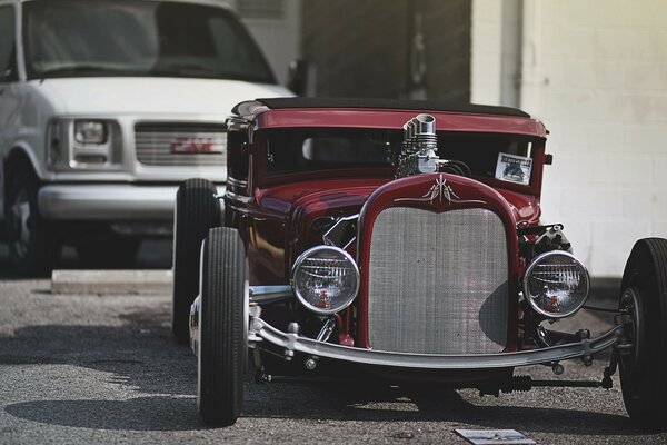 Red retro car in the photo in an aged style