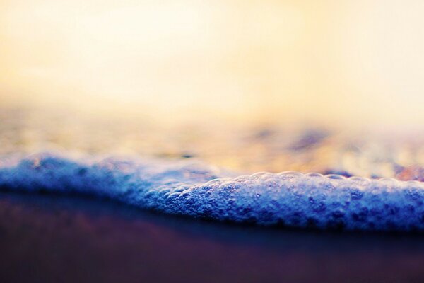 Foam waves on the beach sand