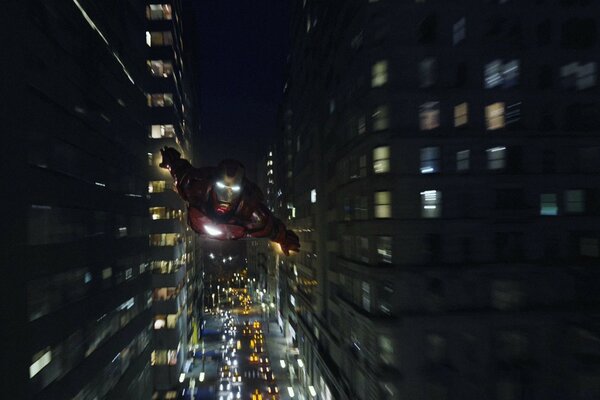 The flight of a super hero through the night city