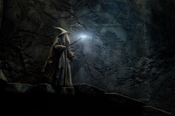 A magician in a cave with a glowing torch