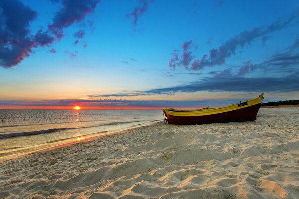 Boat on the sand by the sea