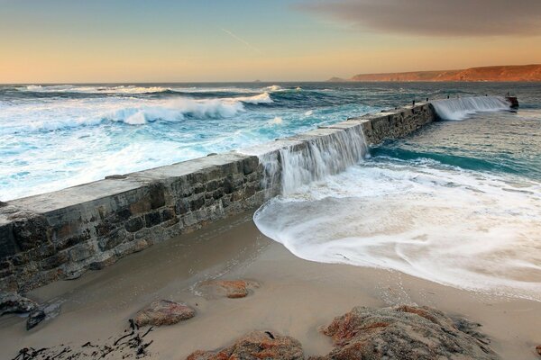 Blue waves break on the sand