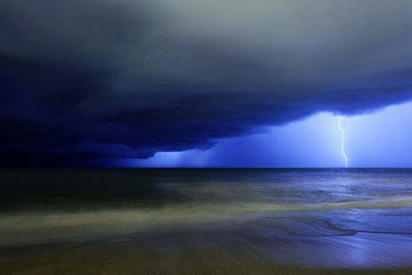 Ocean under a stormy sky at night