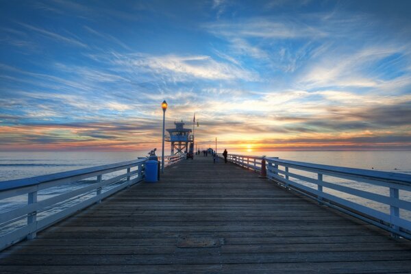 Long pier on the water at sunset