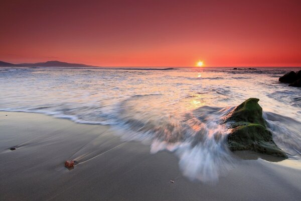 Beautiful sunset by the ocean on the beach