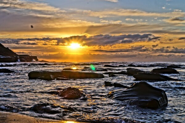 The sun sets over the horizon over the ocean