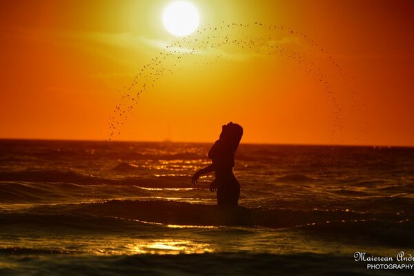 A girl in the sea. Water splashes