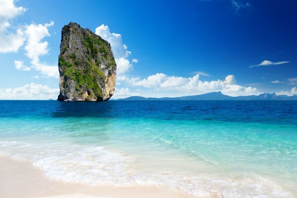 A rock on the shore of a tropical ocean