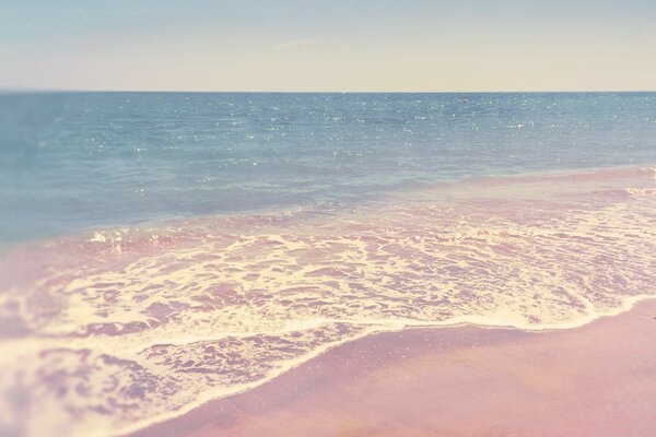 Pink sand and blue ocean water