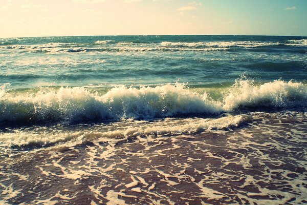 Sea surf breaking on the beach