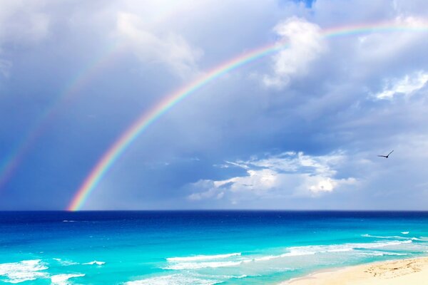 A big rainbow over the waters of the ocean