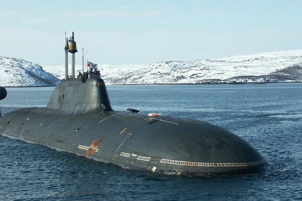 Submarine at sea against the background of snow