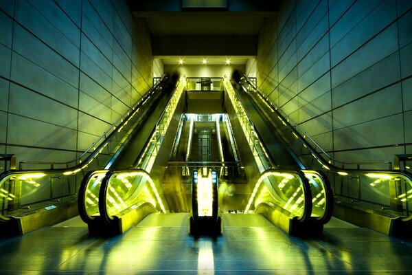 City escalators in yellow lighting